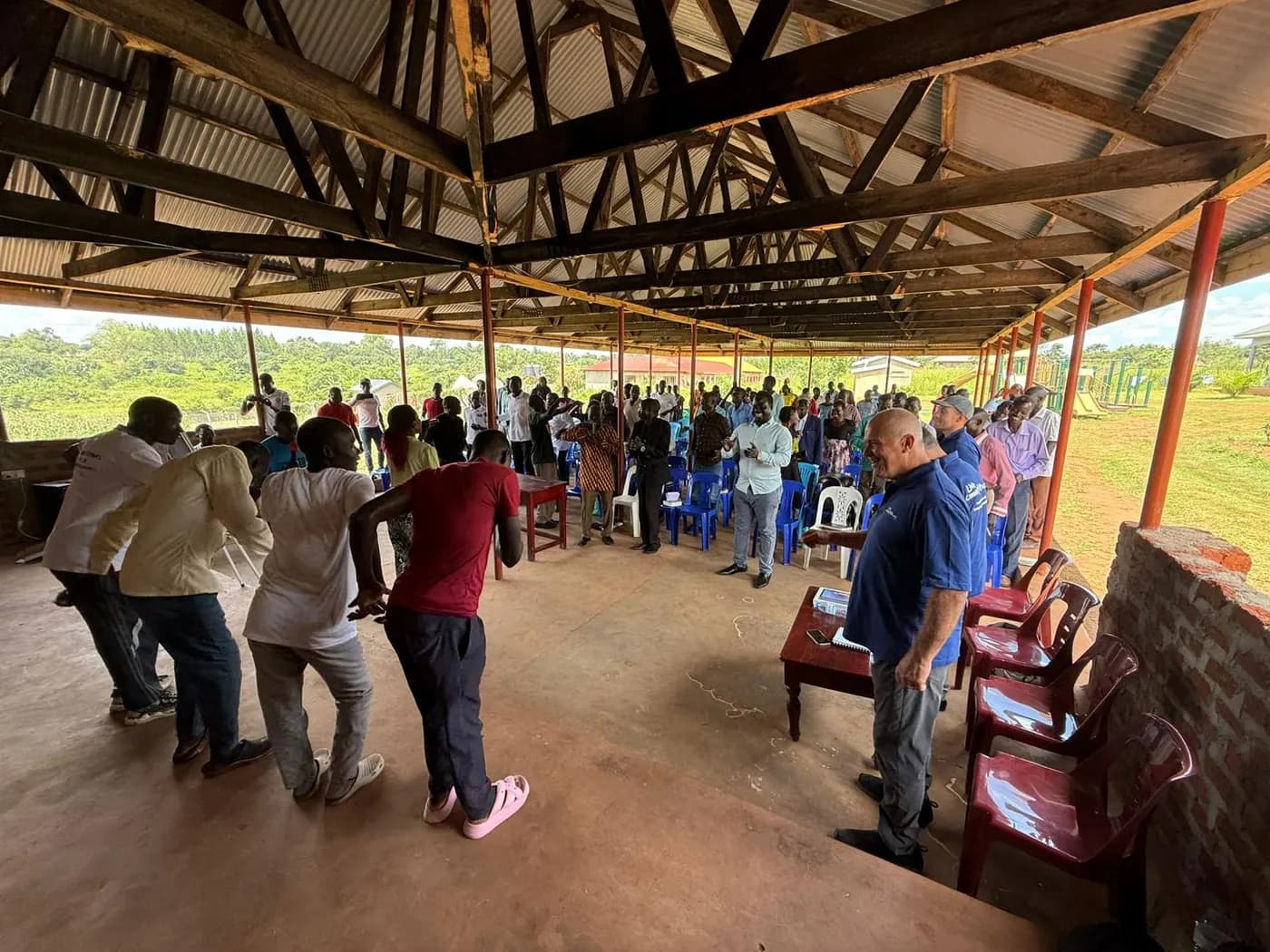 Pastors and mission trip team members gathered for training under an open roof