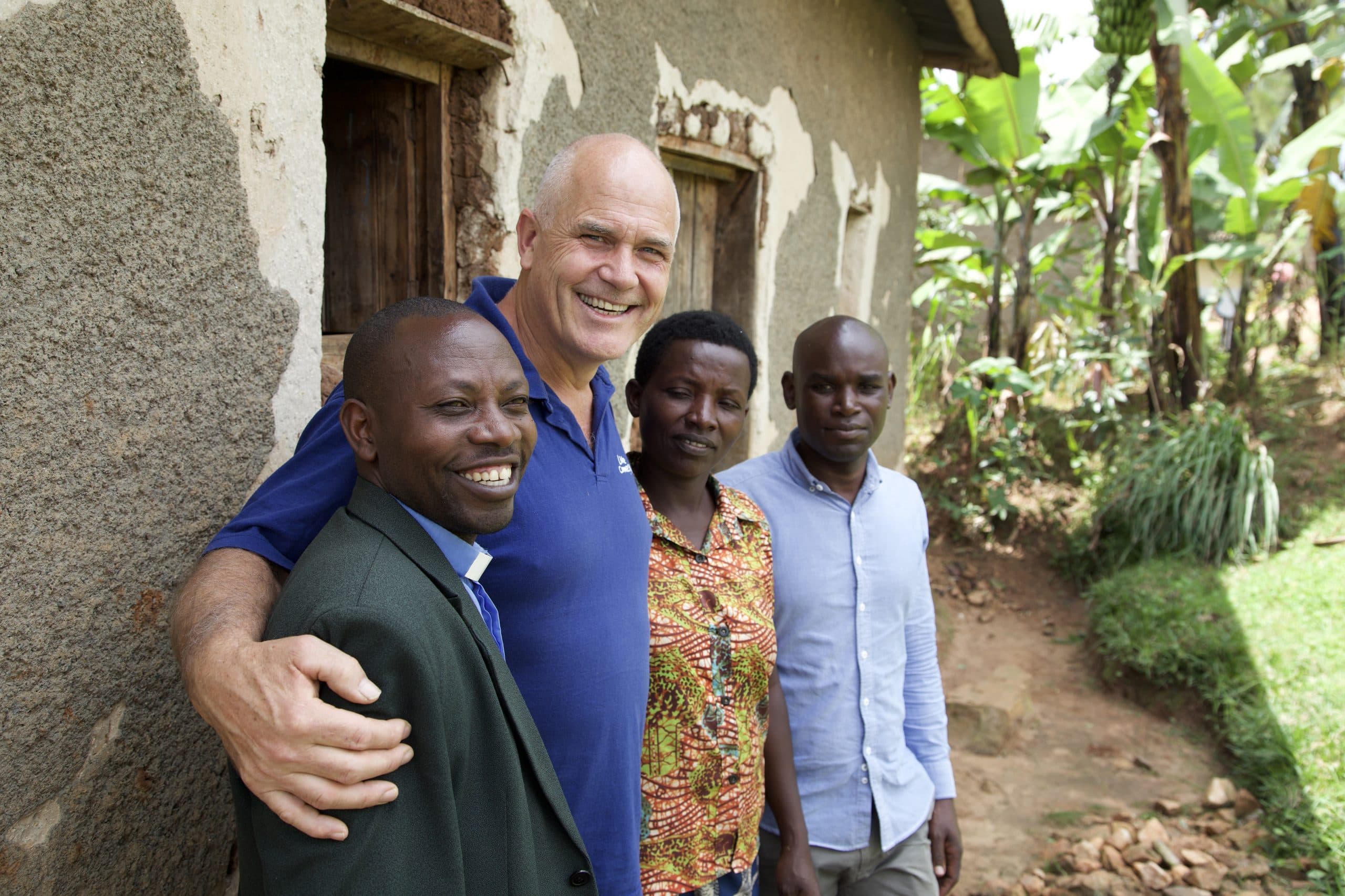Live Connection leader standing with pastors outside a church building.