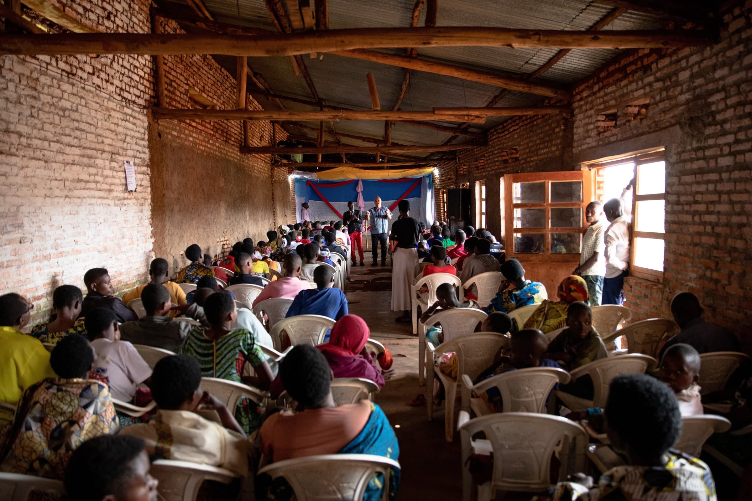 Community gathered outside in Burundi during a Live Connection visit